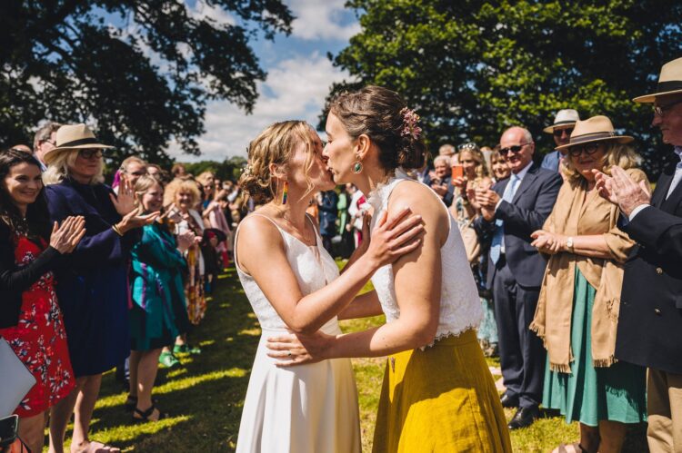 LGBTQ wedding photographer brides enjoying the confetti moment