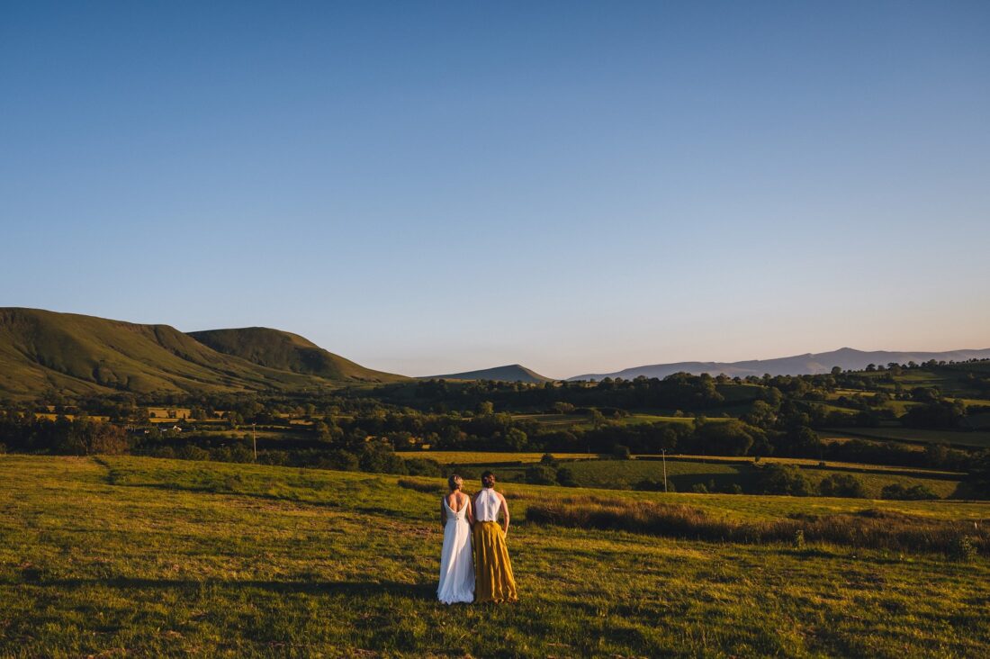 LGBTQ wedding photographer two brides in the golden hour radiating happiness and love