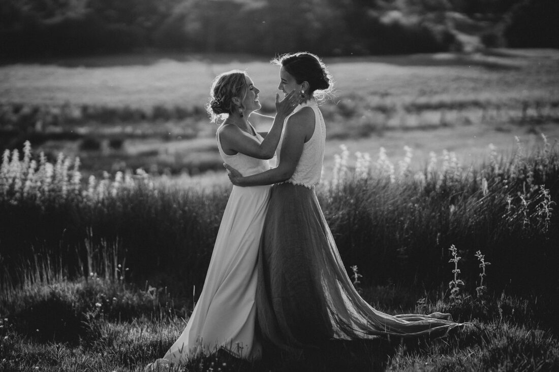 LGBTQ wedding photographer two brides in the golden hour radiating happiness and love
