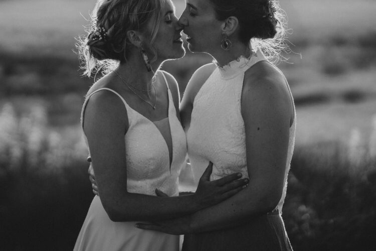 LGBTQ wedding photographer two brides in the golden hour radiating happiness and love