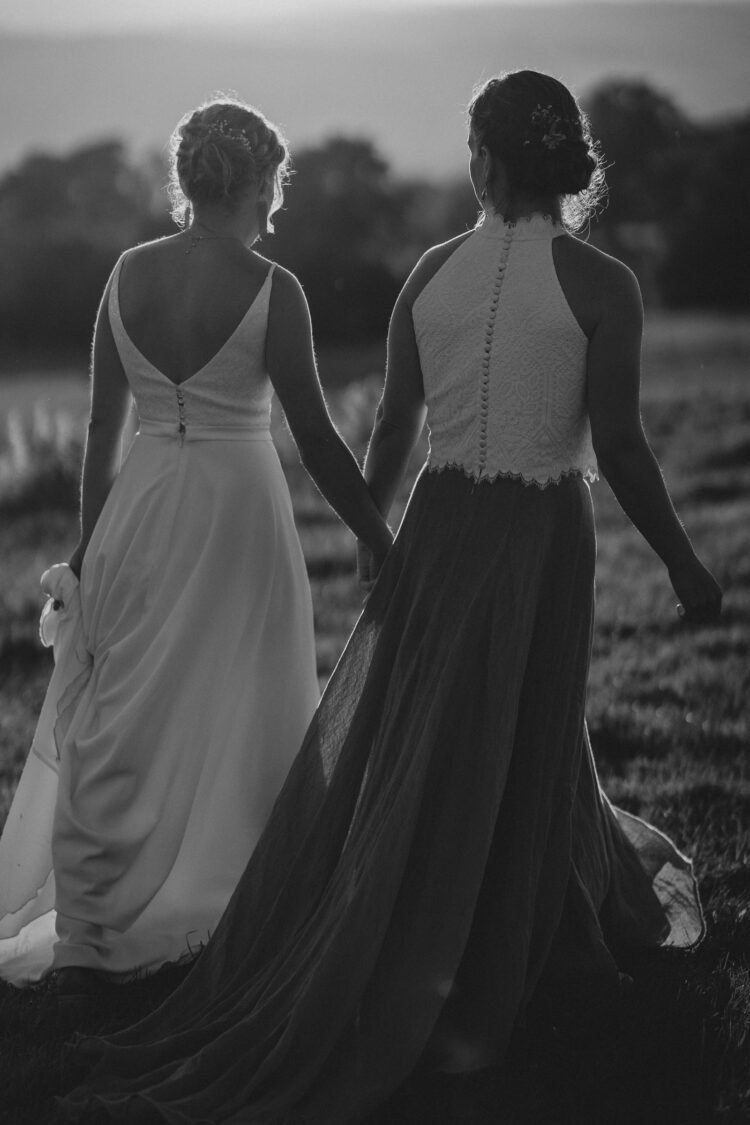 LGBTQ wedding photographer two brides in the golden hour radiating happiness and love