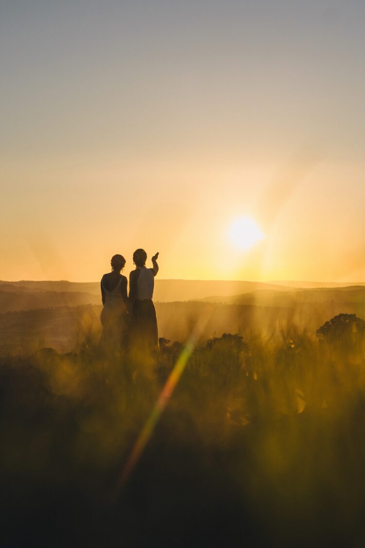 LGBTQ wedding photographer two brides in the golden hour radiating happiness and love