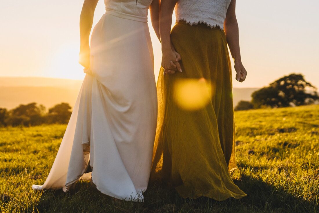 LGBTQ wedding photographer two brides in the golden hour radiating happiness and love