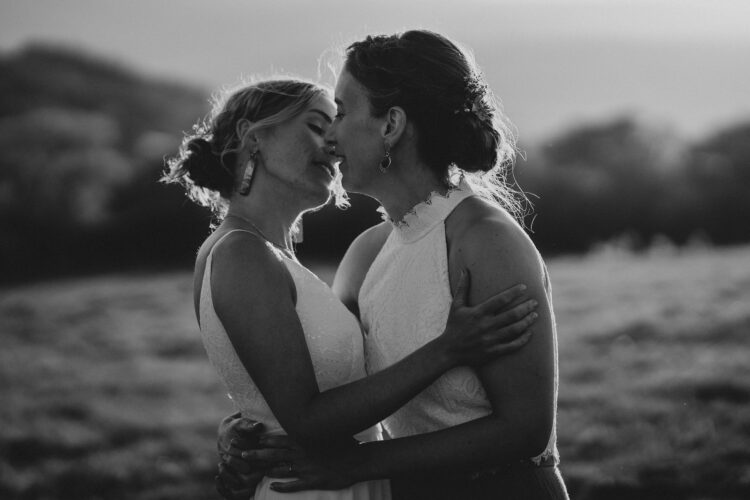 LGBTQ wedding photographer two brides in the golden hour radiating happiness and love