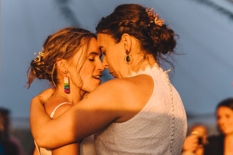 LGBTQ wedding photographer brides having the first dance in the golden hour