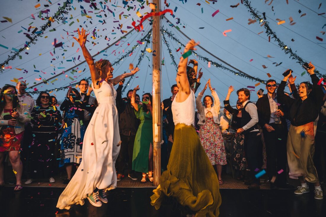 LGBTQ wedding photographer brides having the first dance in the golden hour, marquee and tipi wedding photography