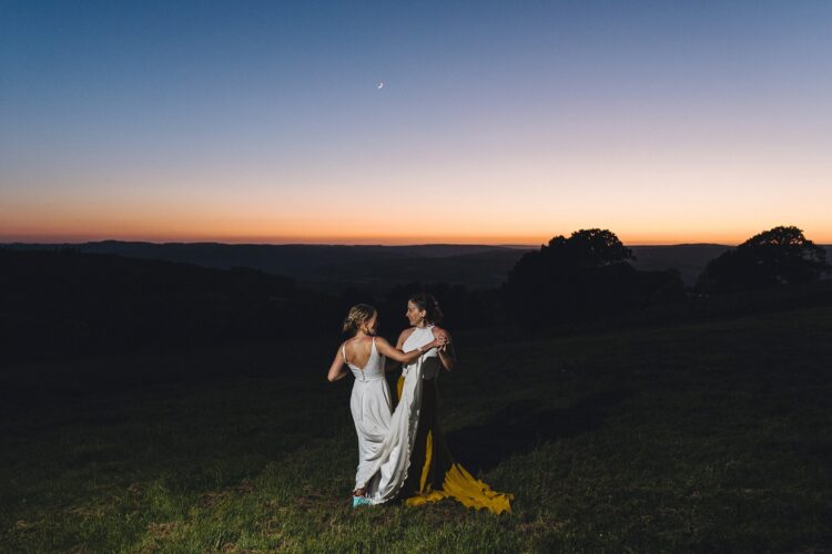 LGBTQ wedding photographer two brides in the blue hour radiating happiness and love