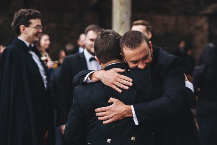 groom welcoming guests at Dewsall Court