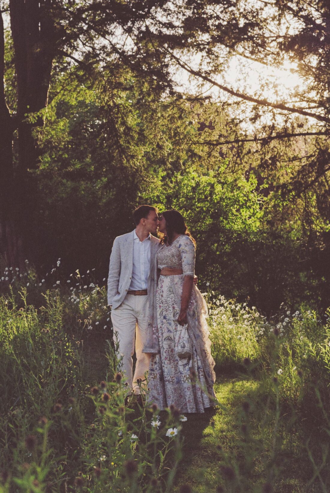 analogue wedding photography at sezincote house, couple kissing in the gardens