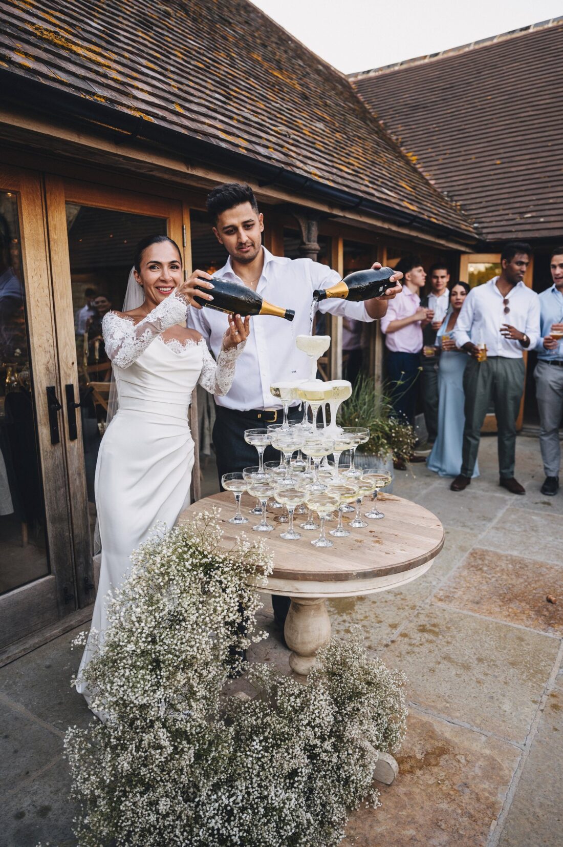 bride and groom having their champagne moment at the old gore barn