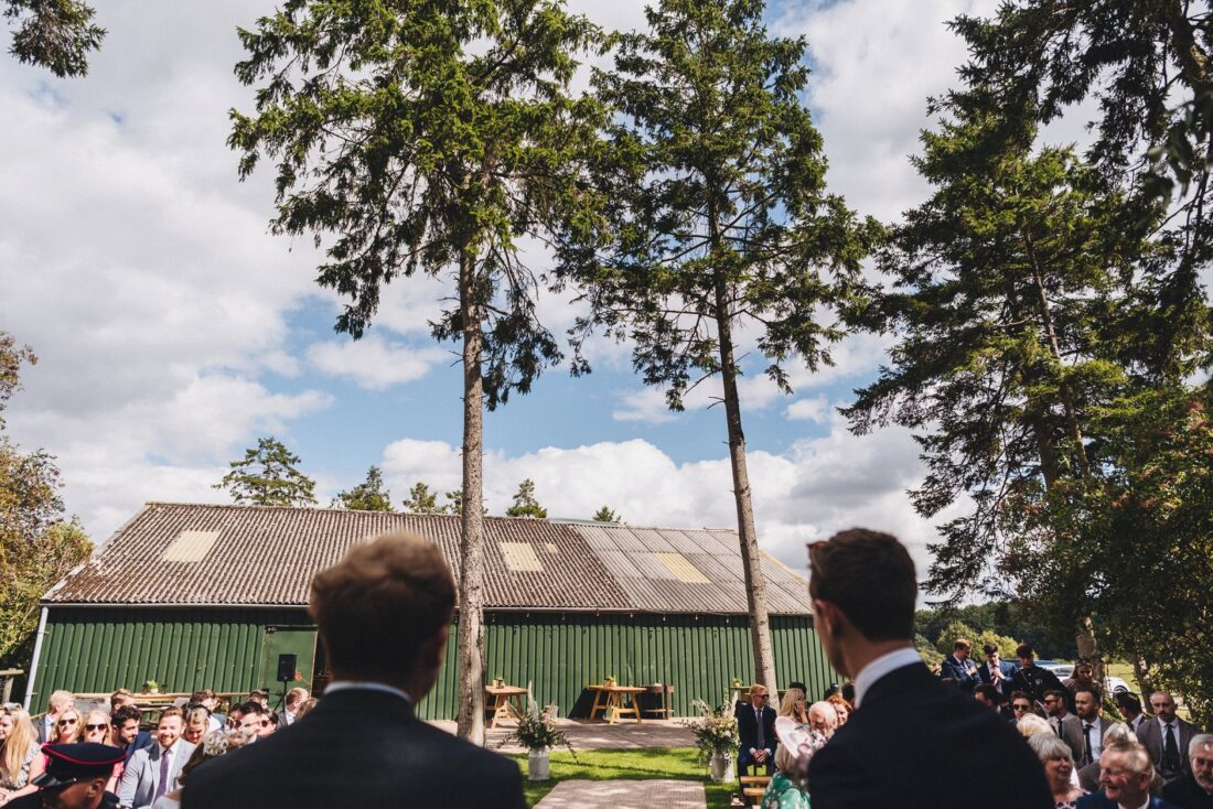 guests waiting for the couple to arrive at the ceremony at redbank barn