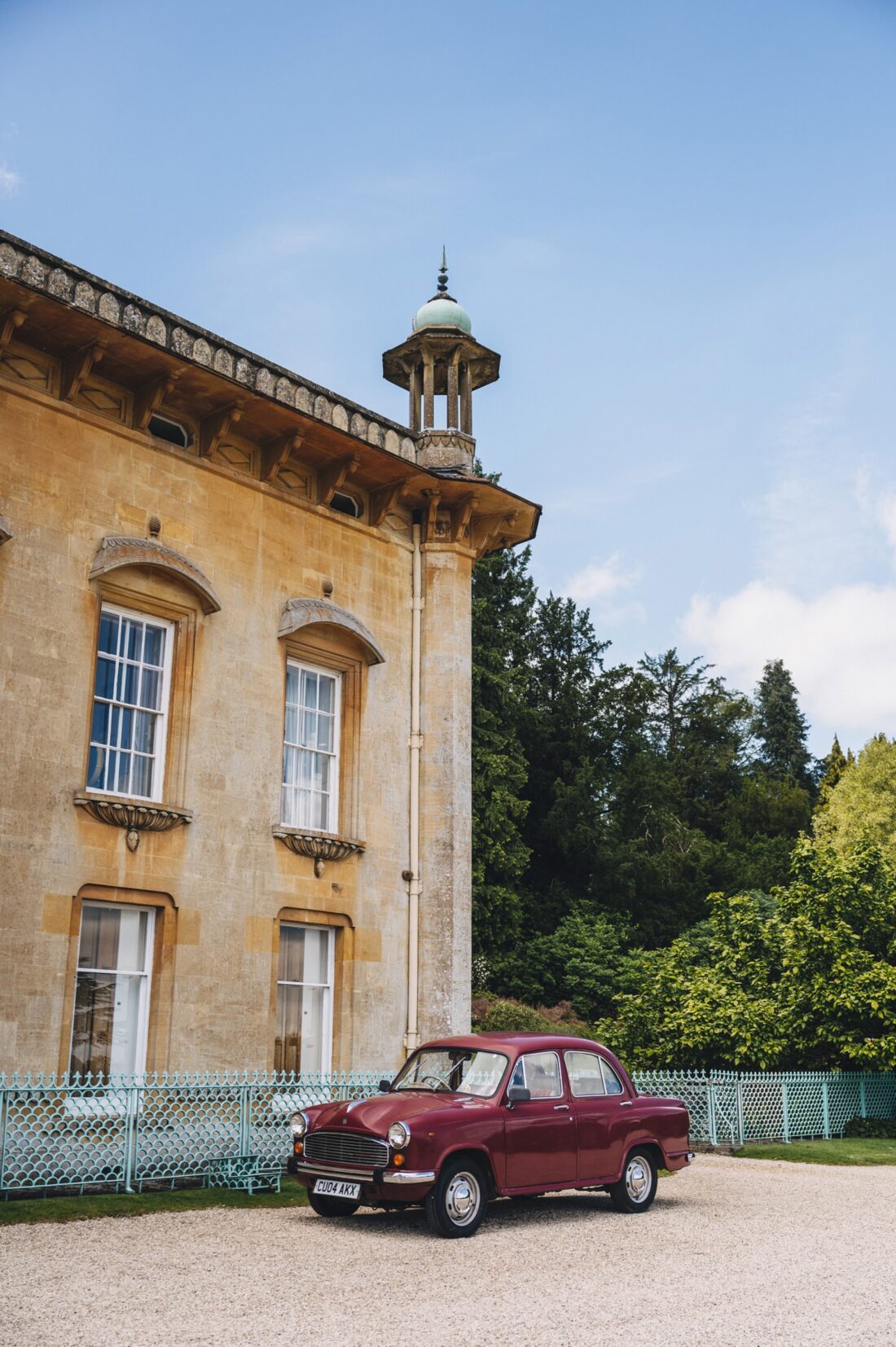 the Sezincote House building with an old car